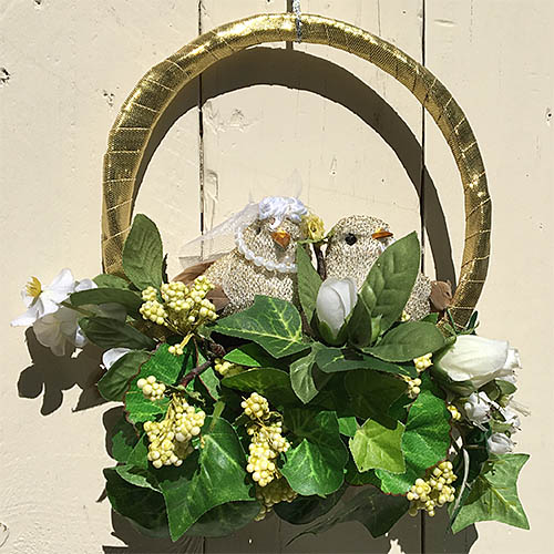 Small wreath with upcycled flowers and foliage and purchased lovebird ornaments.